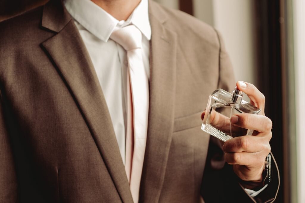 man spraying perfume