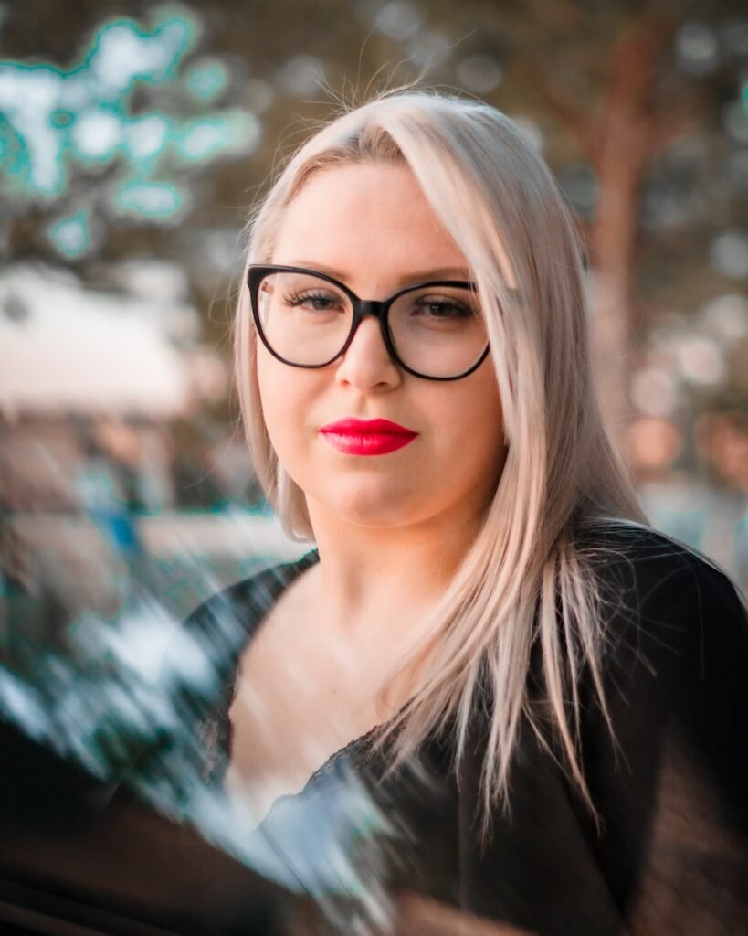 woman in black scoop neck shirt with red lipstick