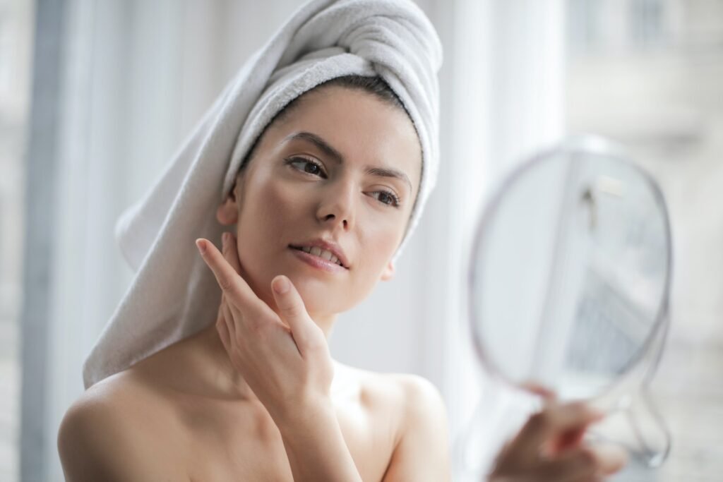 Woman With a Towel on Head Looking in the Mirror