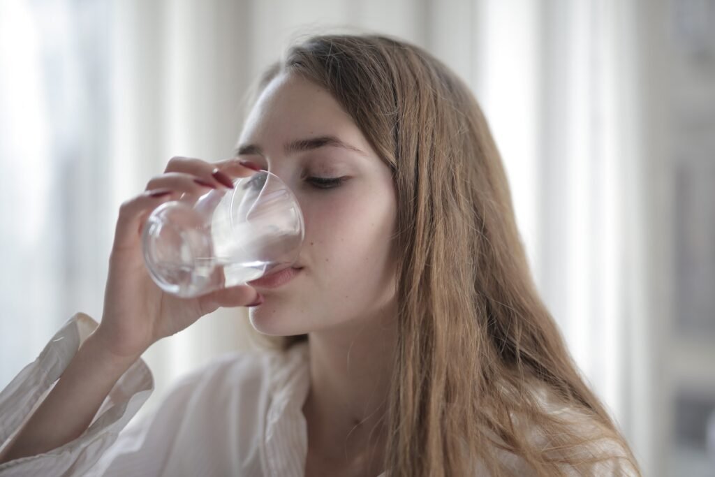 Young woman drinking glass of water