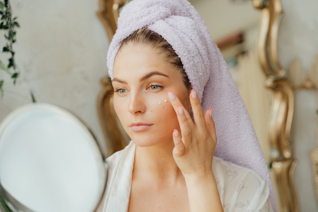 selective-focus-portrait-photo-of-woman with a towel on head looking in the mirror