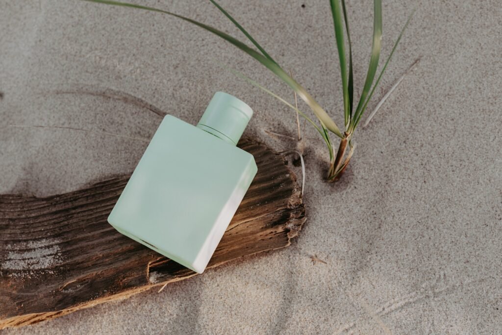 Green Plastic Perfume Bottle on Wooden Surface