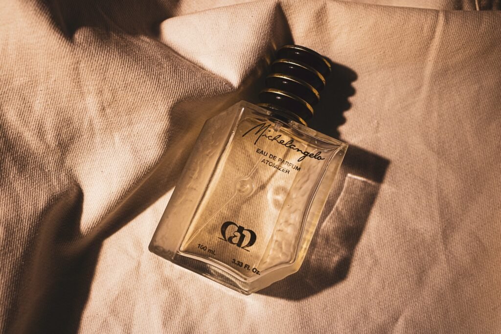 gold perfume bottle on white textile