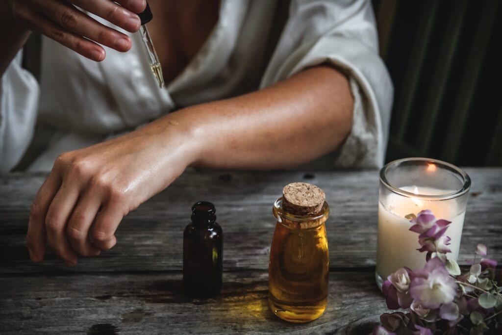 Woman rubbing oil on skin