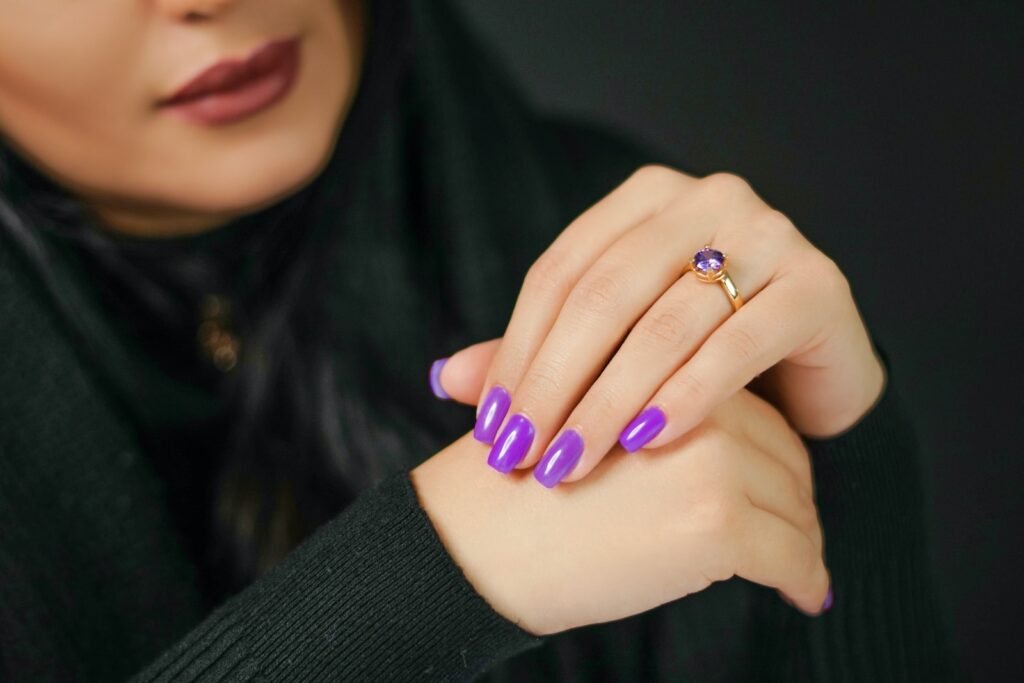 A Close-Up Shot of a Woman Wearing a Gold Ring