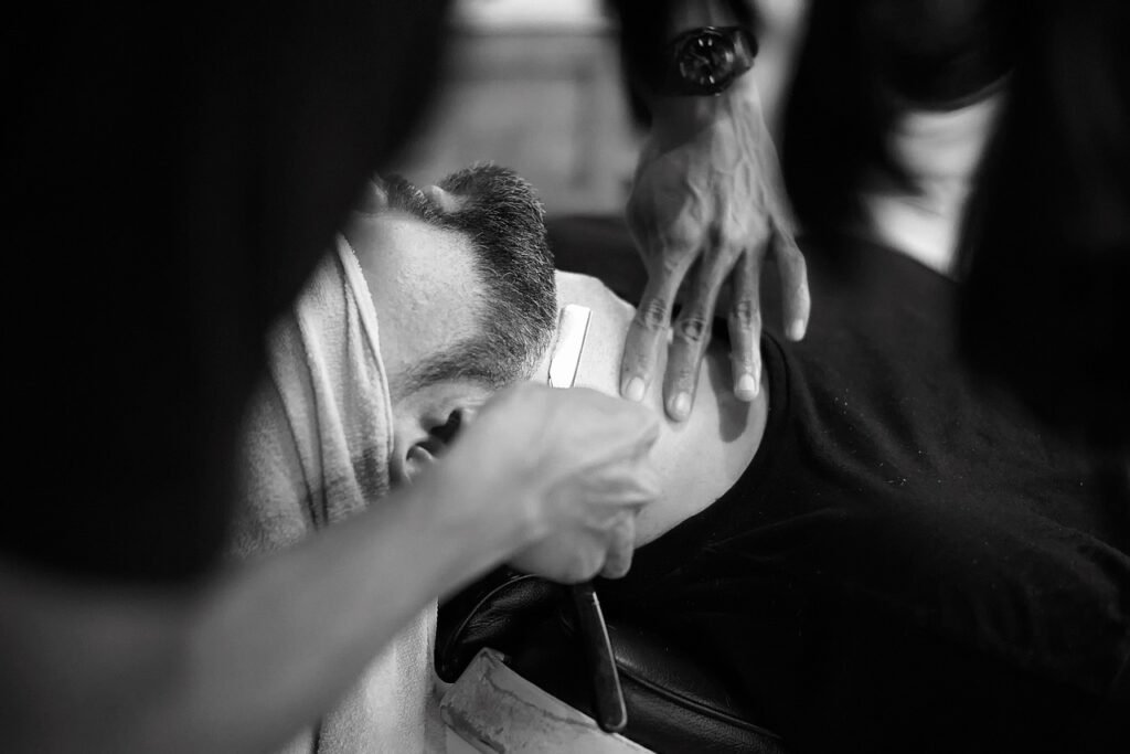 Person Shaving the Man's Beard