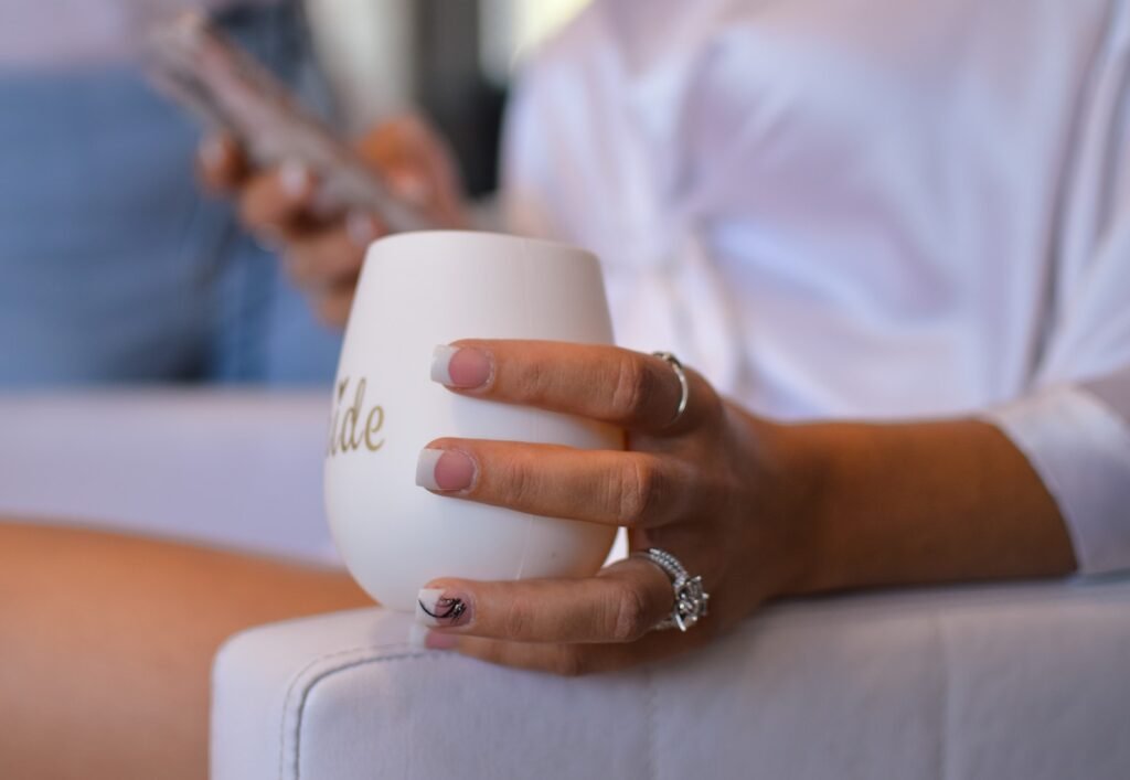 Woman Holding White Cup