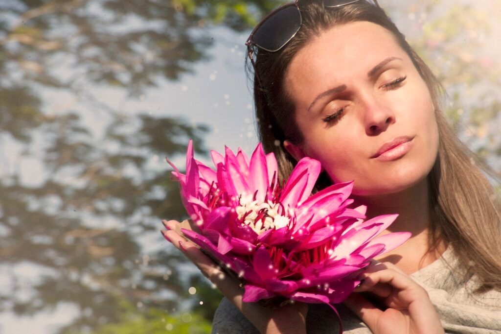 Woman Holding Pink Water Lily Flowers