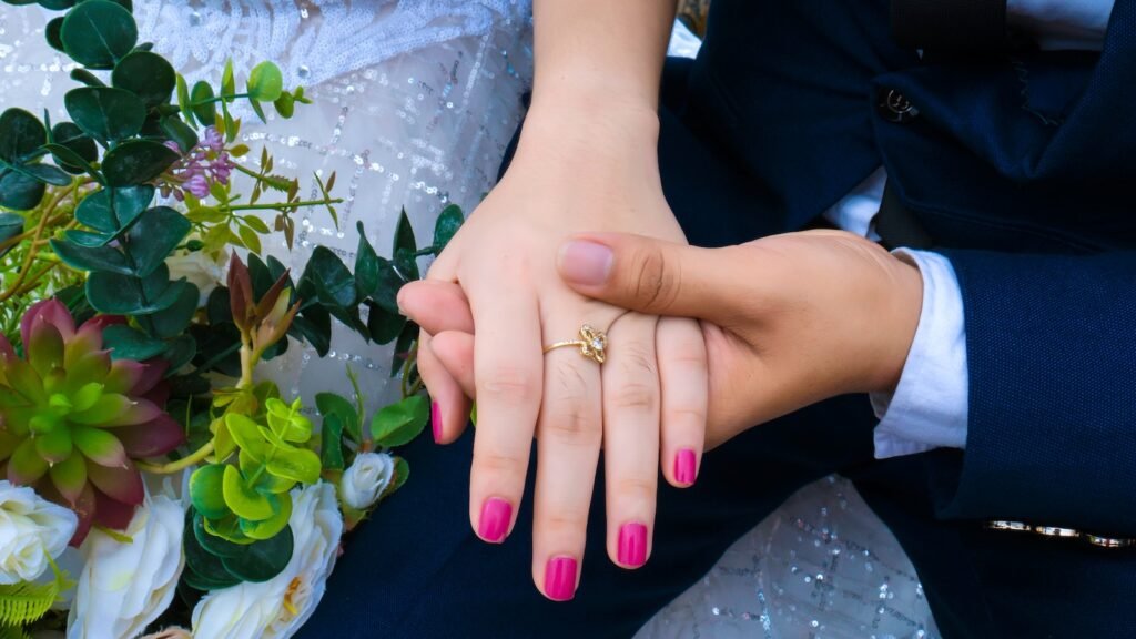 Unrecognizable newlywed couple in wedding clothes holding hands