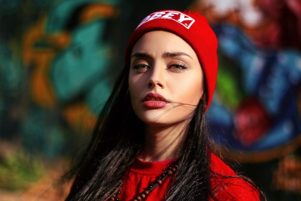 Stylish woman with makeup in red knitted hat